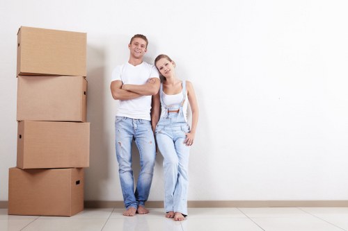 Moving team loading furniture safely with protective gloves and careful handling