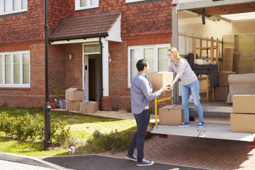 Moving boxes and furniture being loaded for house removals in Paddington