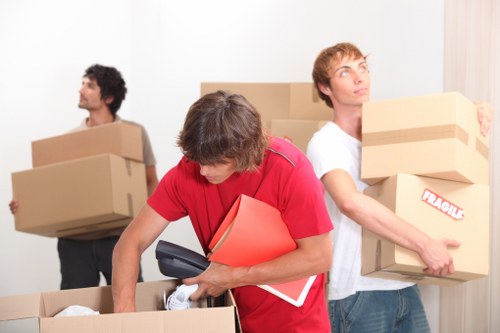 Careful loading of household items into a Paddington removal van