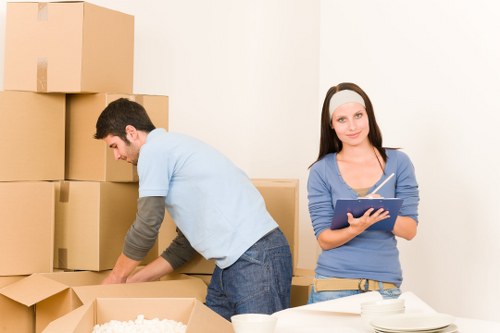 Movers carefully packing fragile items in a Paddington home