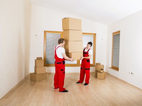 Movers carrying large furniture through a Paddington property